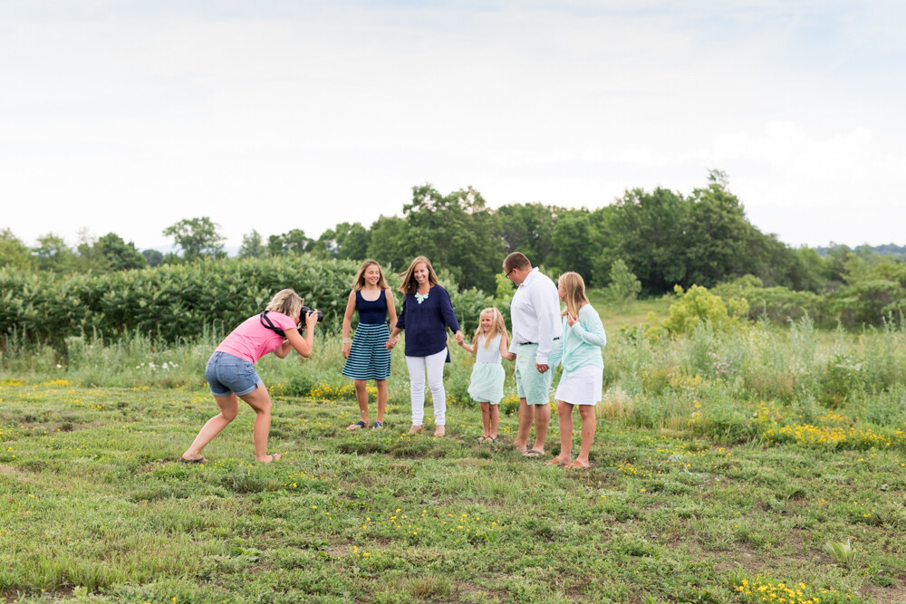 kristy dooley photographing family in field