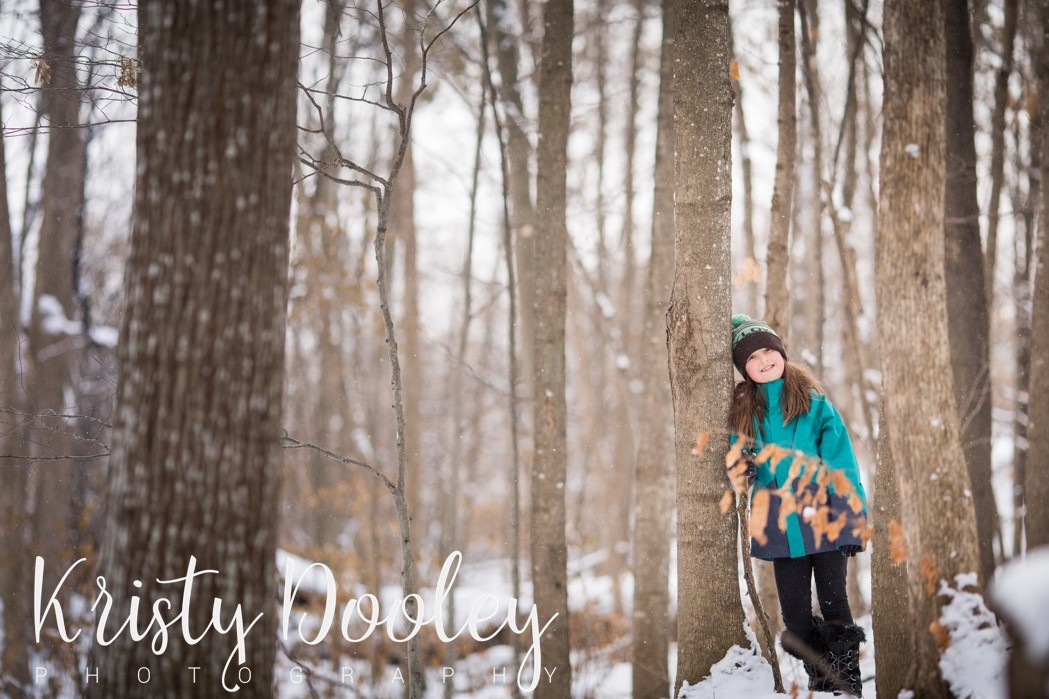 girl smiling in snowy forest