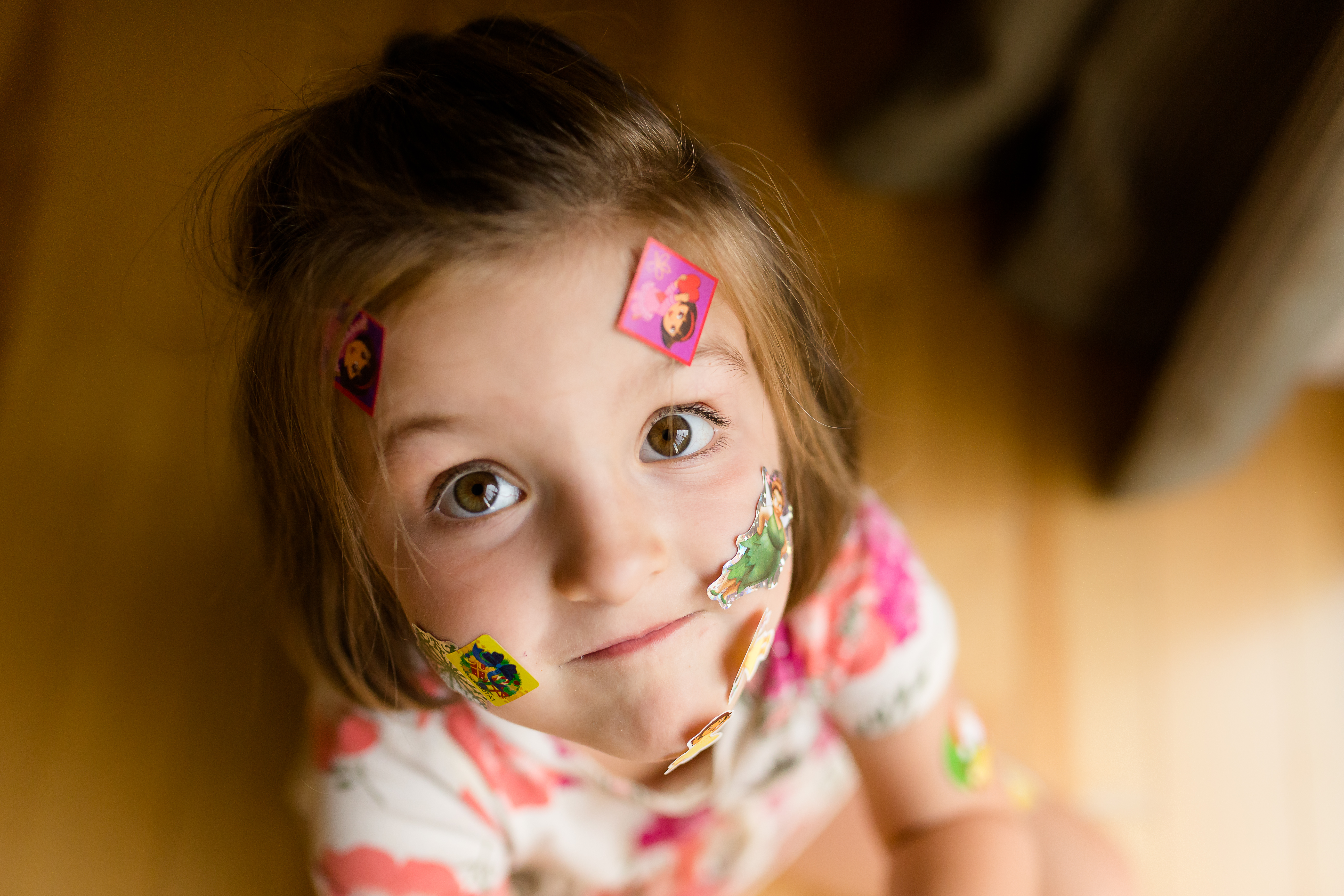 little girl with stickers on face