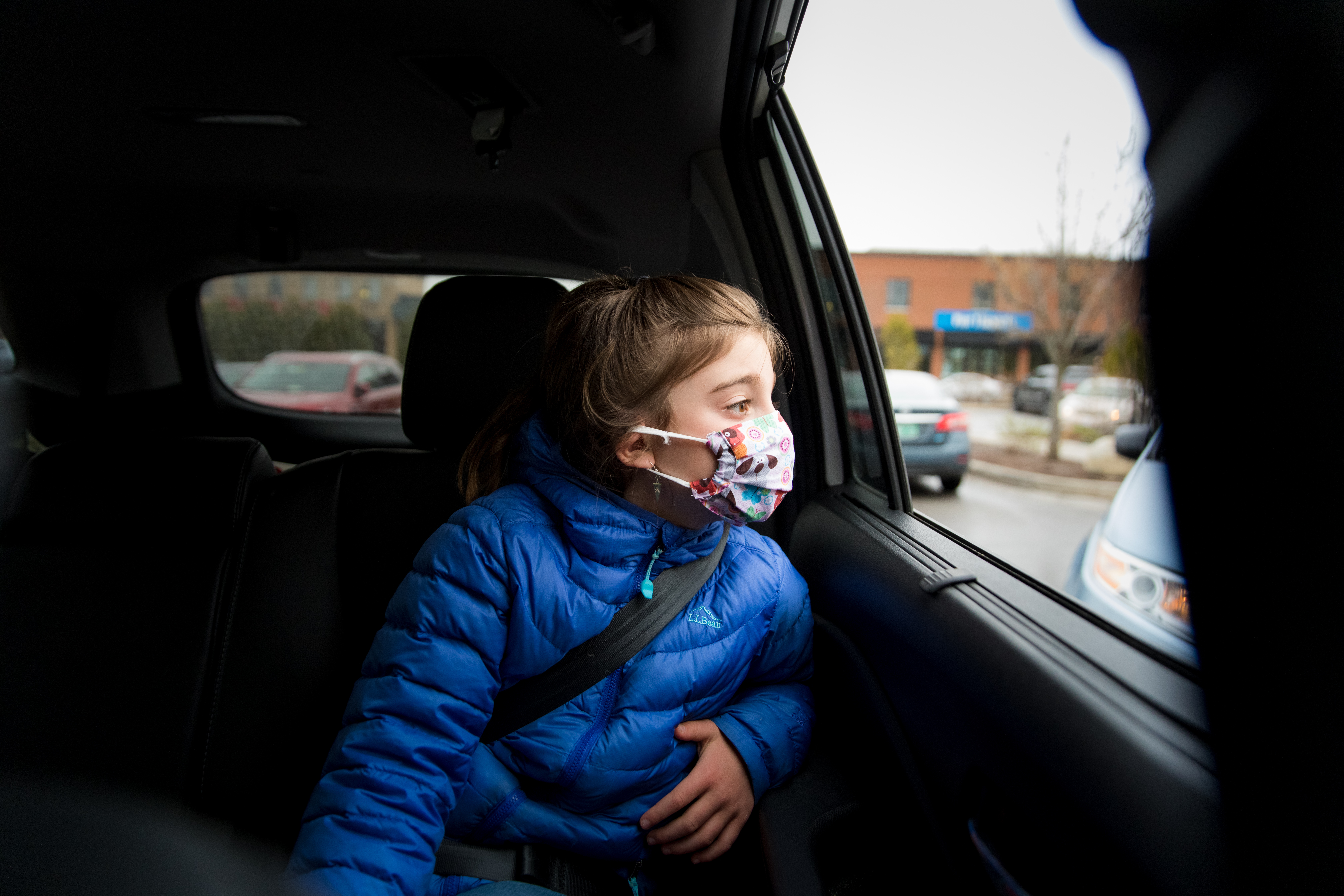 girl with covid mask on in car