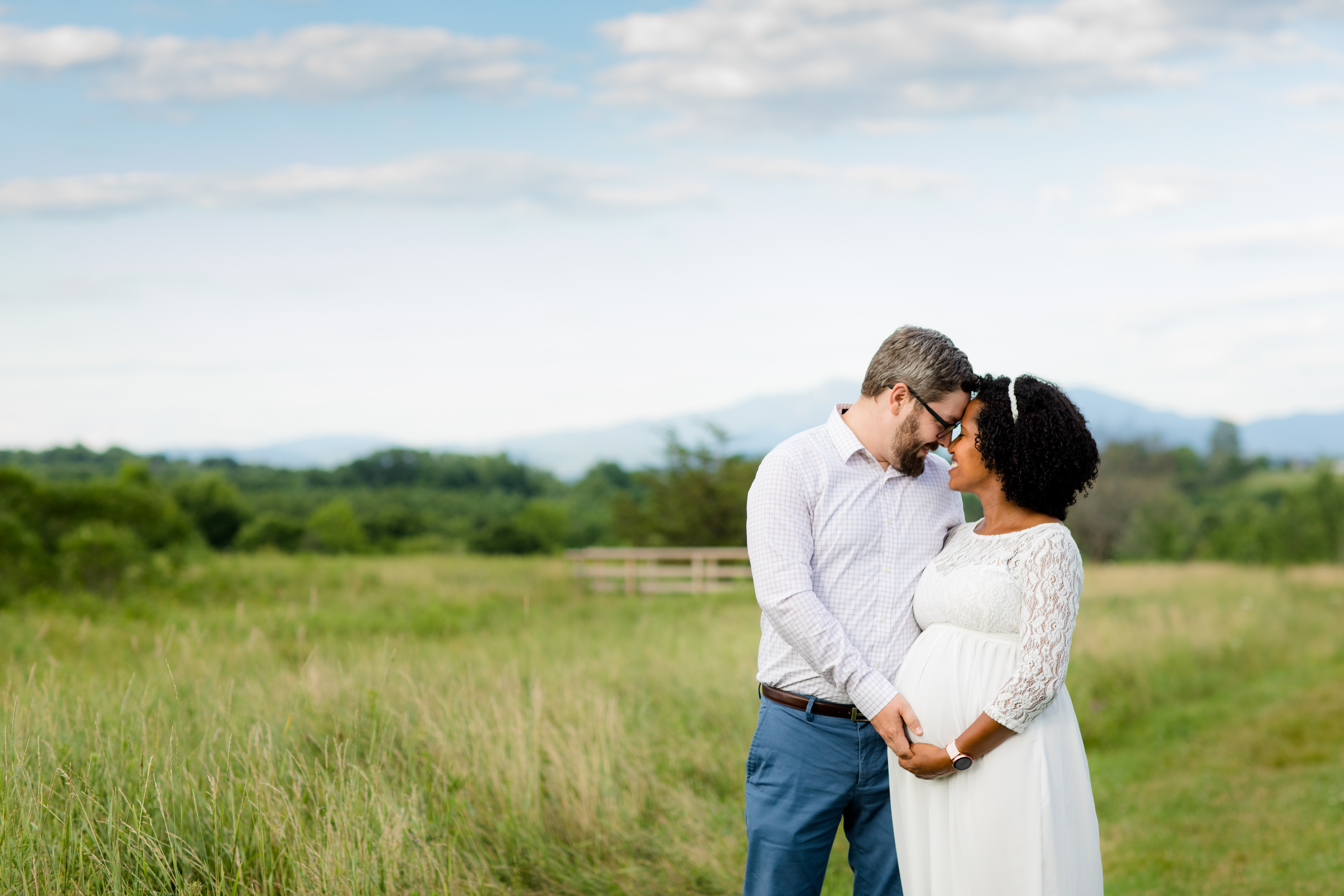 husband and pregnant wife field photograph