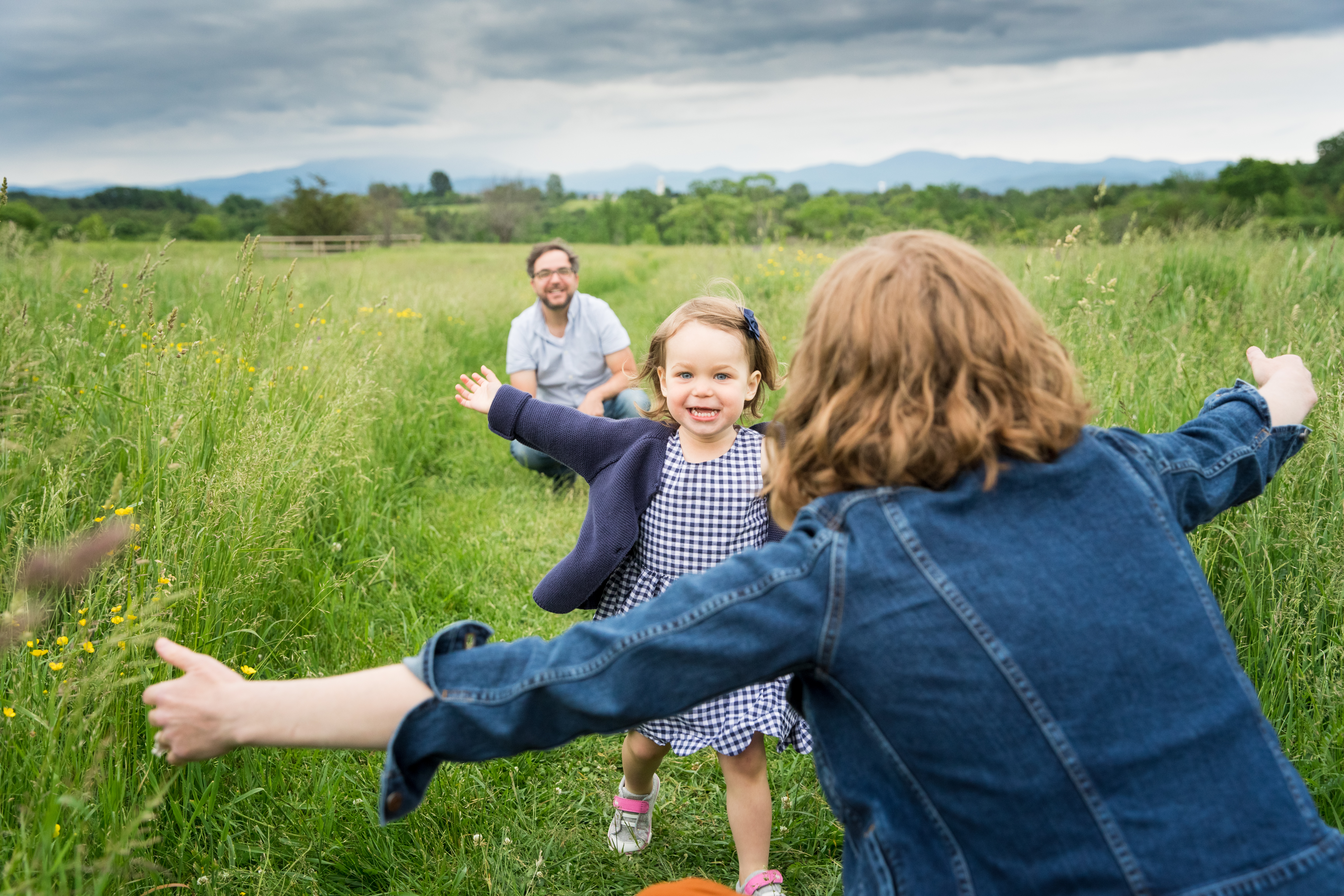parents and daughter in field photography